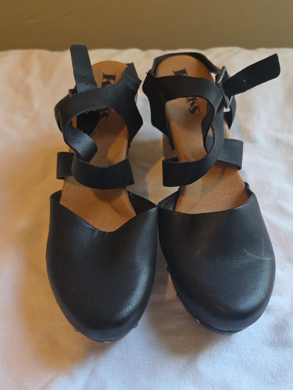 Korks black heeled clogs with a crisscross strap